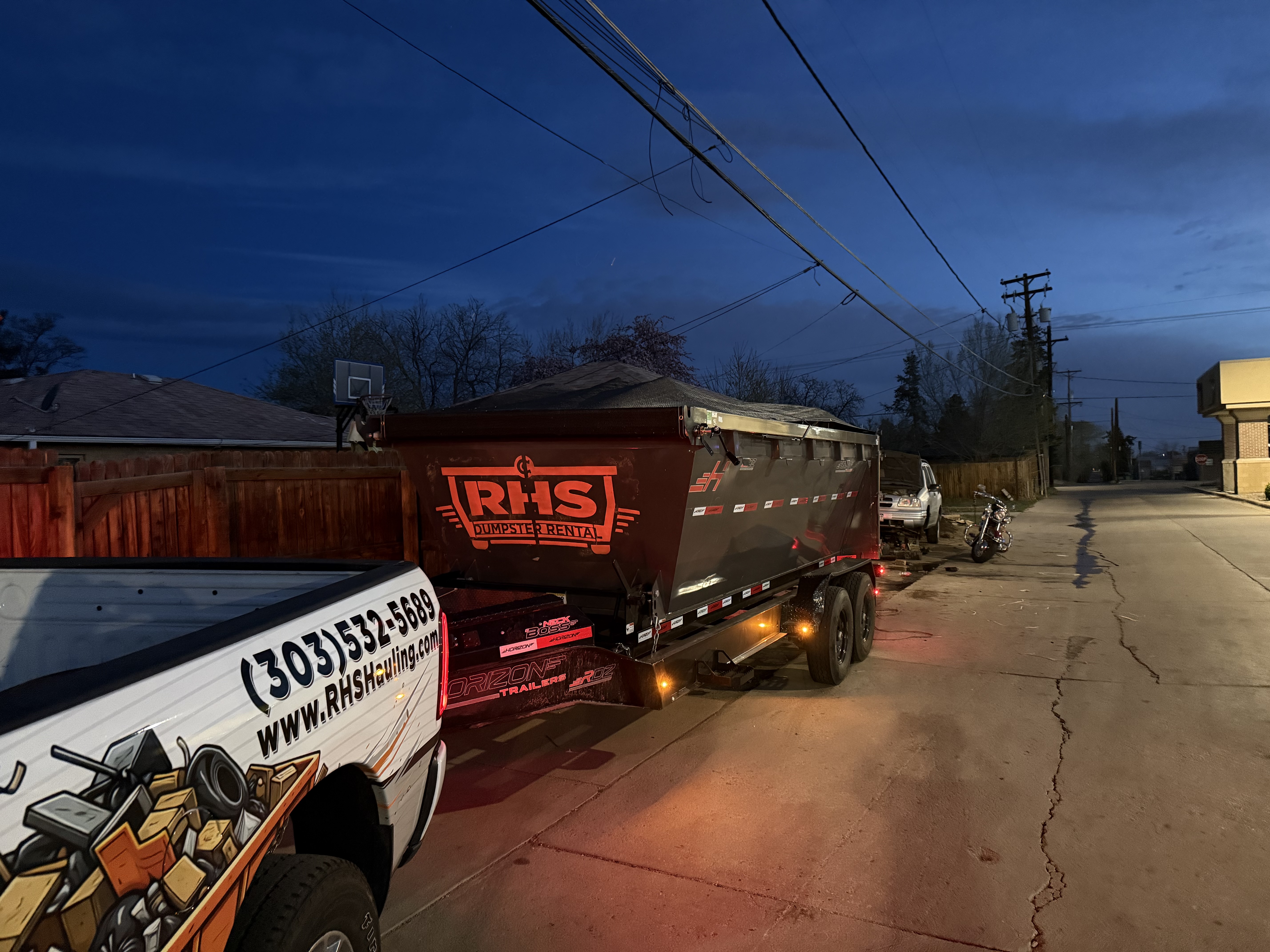 RHS dumpster delivery at dusk