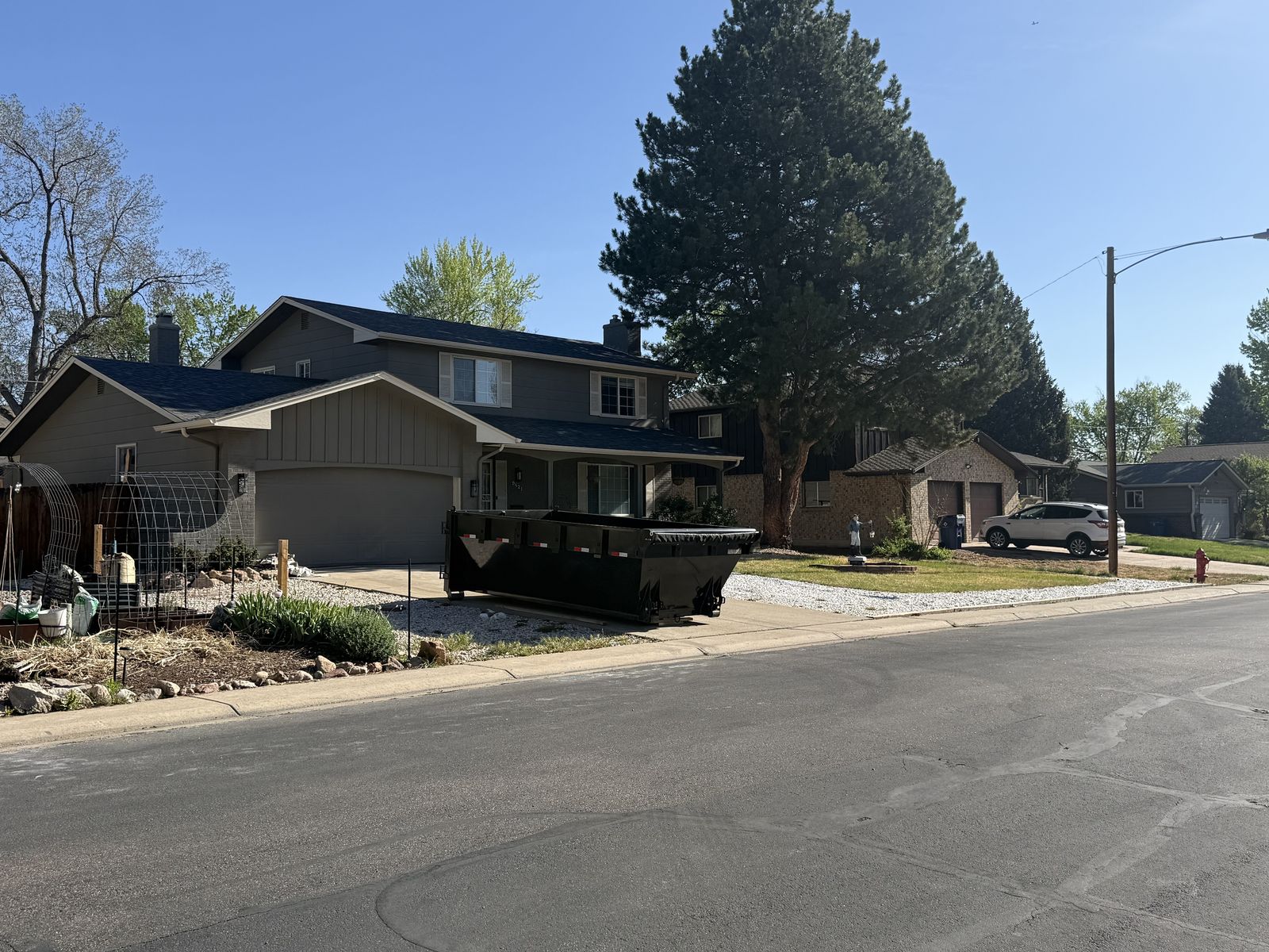 Low-profile 15-yard RHS dumpster on a residential driveway