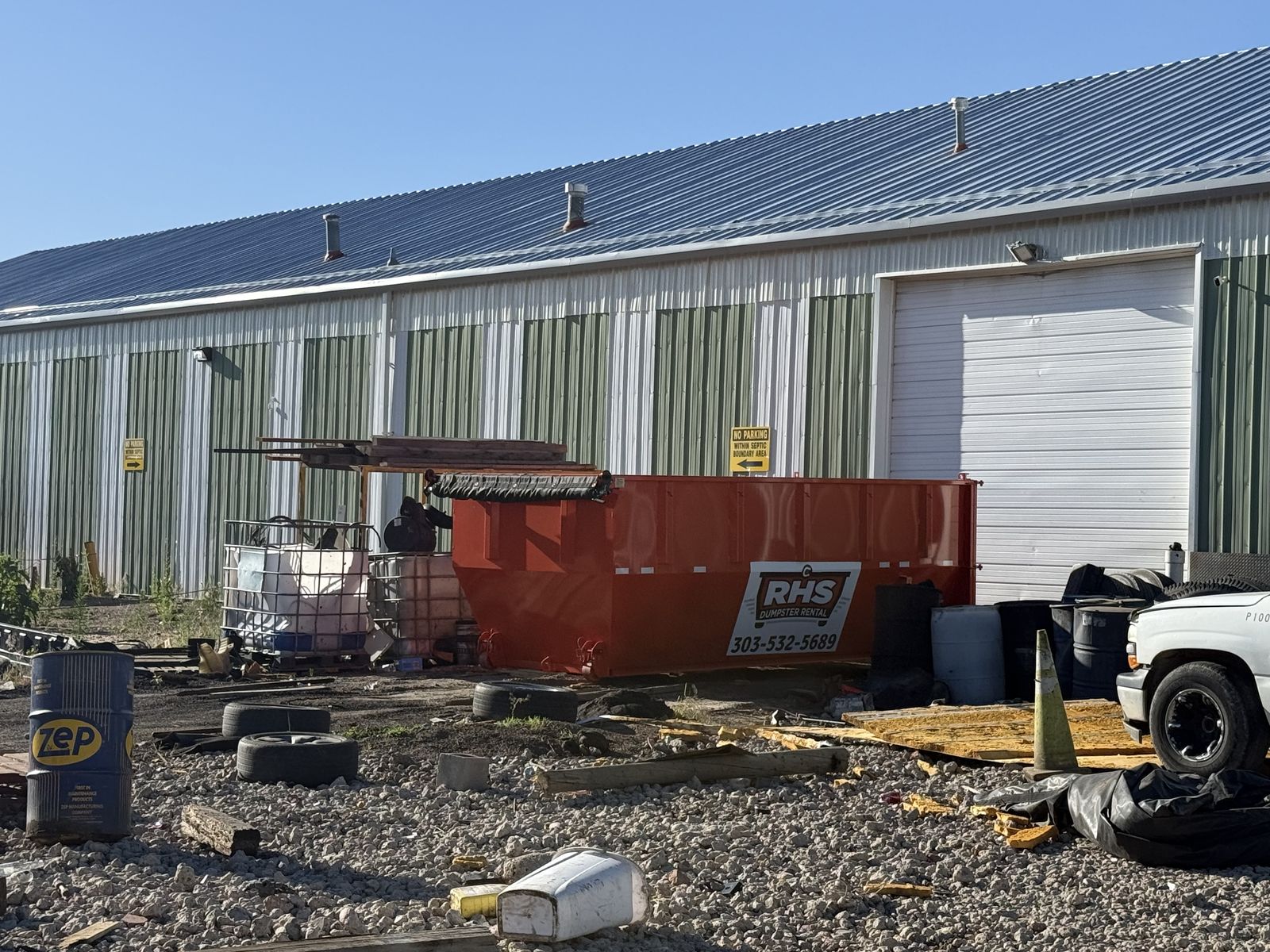 Orange 20-yard RHS dumpster at a commercial job site